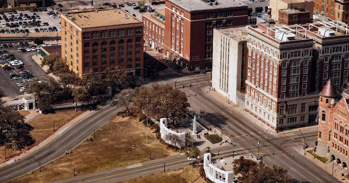 Dealey Plaza from above, with the old Book Depository at the top left. Illustration.